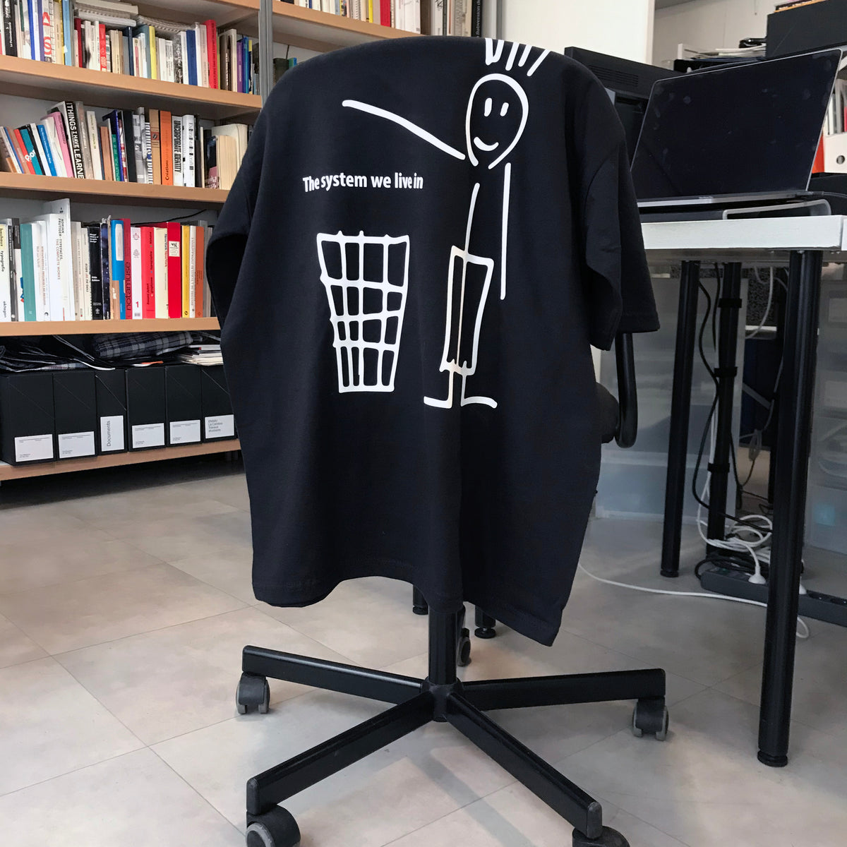 ‘The System We Live In’ Tee